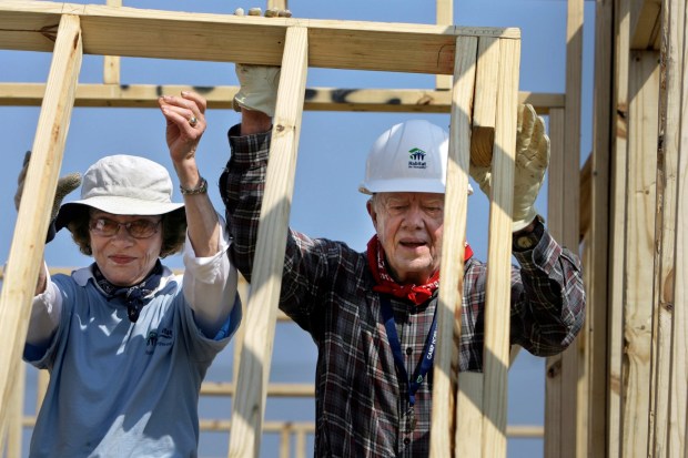 Former President Jimmy Carter, right, and former first lady Rosalynn Carter help build a Habitat for Humanity house in Violet, La.