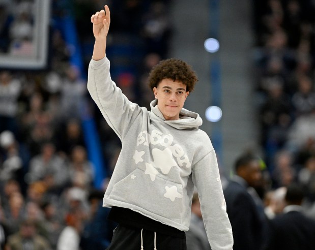 UConn 2025 recruit Darius Adams gestures to the fans during an NCAA college basketball game between UConn and Maryland-Eastern Shore, Saturday, Nov. 30, 2024, in Hartford, Conn. (AP Photo/Jessica Hill)