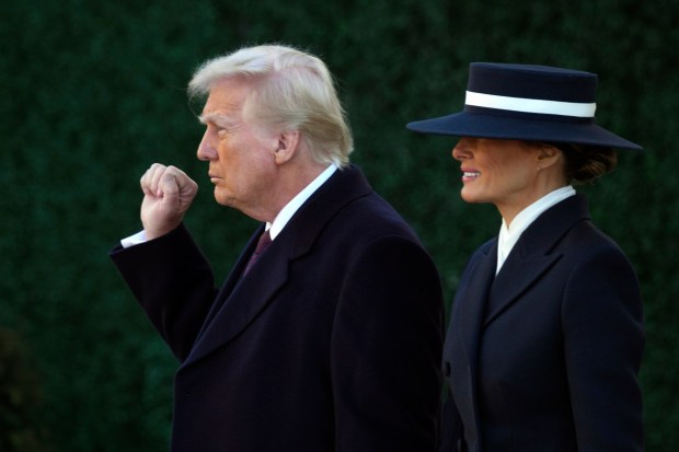 President-elect Donald Trump gestures as he walks with his wife Melania after a church service at St. John's Episcopal Church across from the White House in Washington, Monday, Jan. 20, 2025, on Donald Trump's inauguration day. (AP Photo/Matt Rourke)