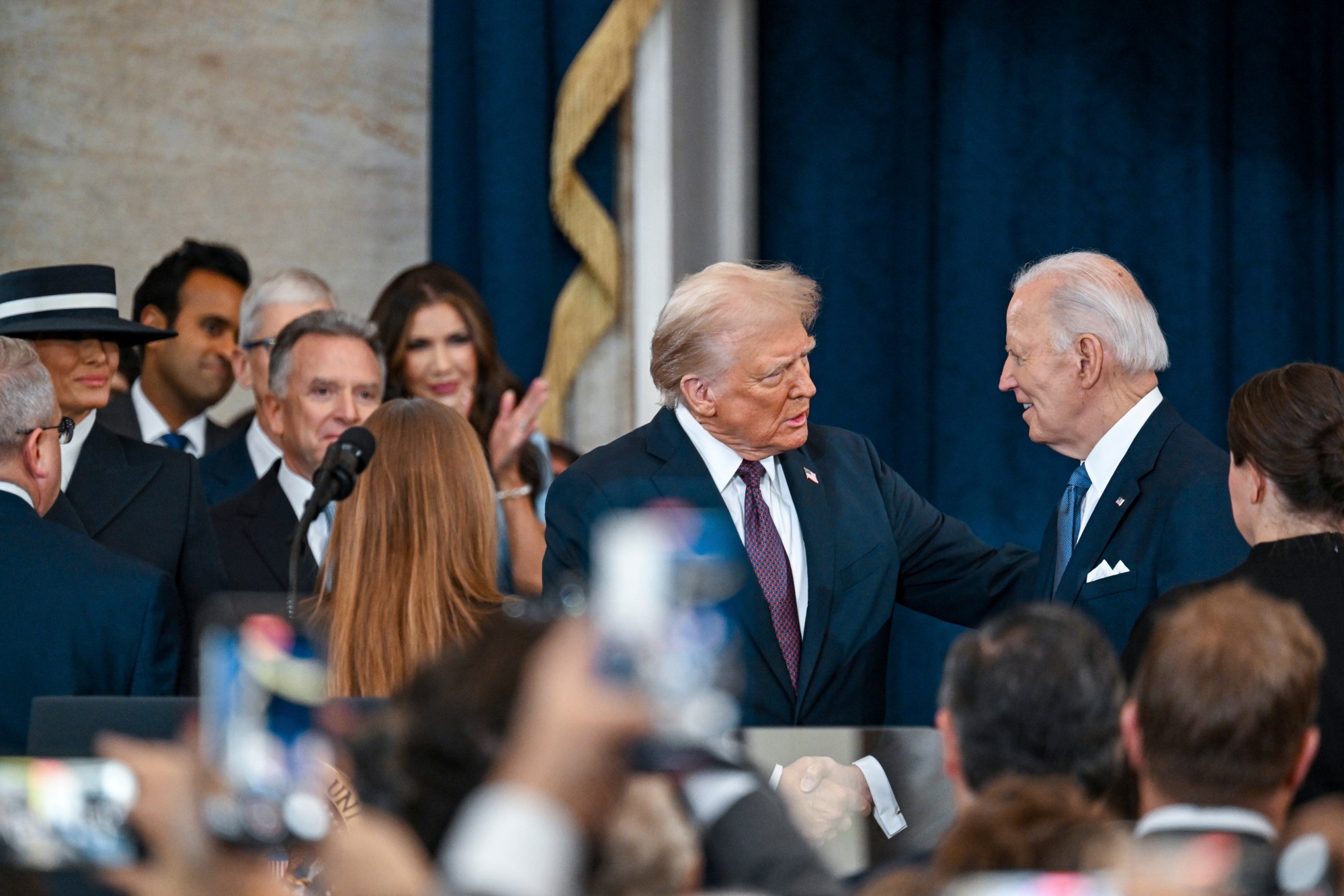President-elect Donald Trump, left, greets President Joe Biden at the 60th Presidential Inauguration in the Rotunda of the U.S. Capitol in Washington, Monday, Jan. 20, 2025. (Kenny Holston/The New York Times via AP, Pool)