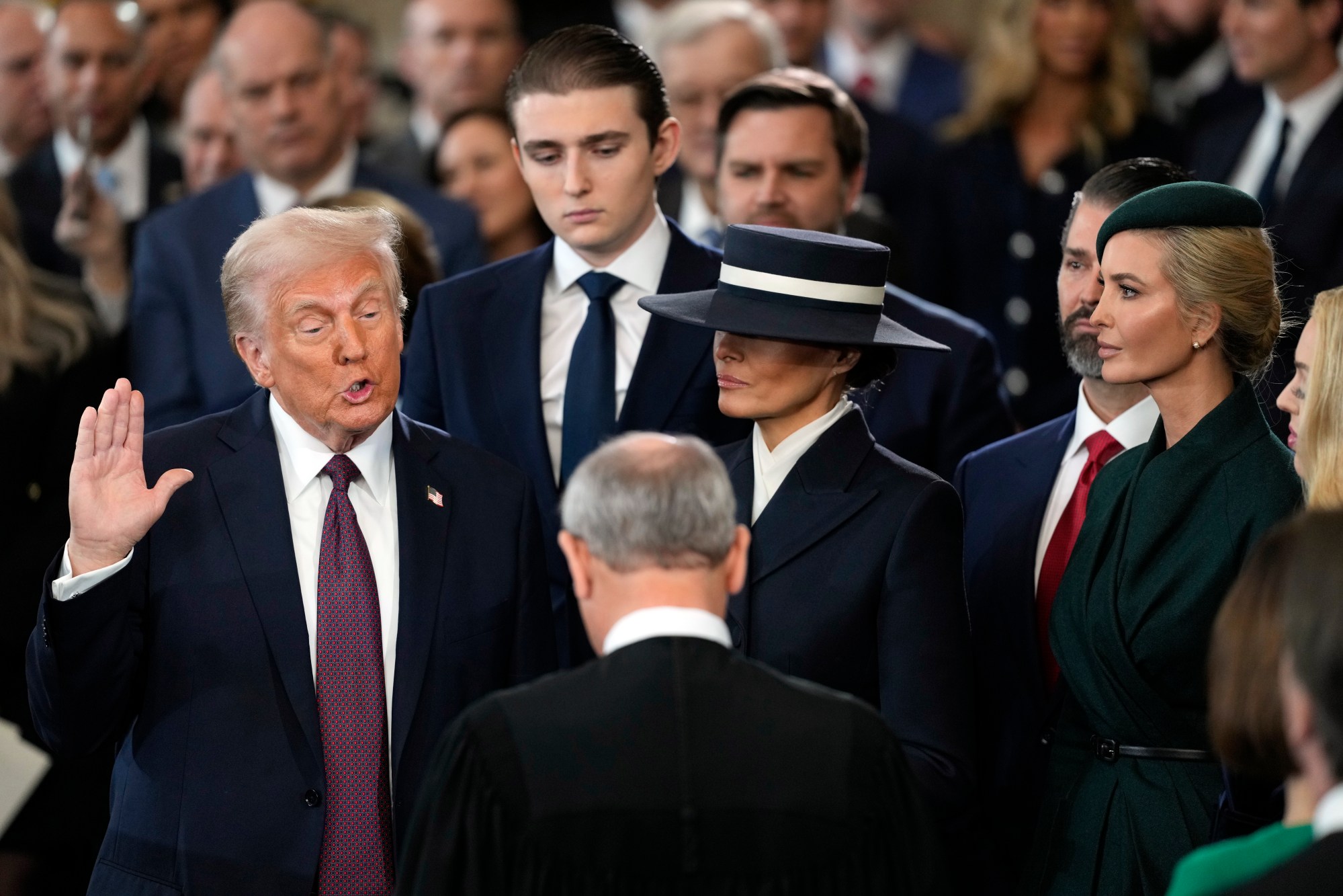Donald Trump is sworn in as the 47th president of the United States by Chief Justice John Roberts as Melania Trump holds the Bible during the 60th Presidential Inauguration in the Rotunda of the U.S. Capitol in Washington, Monday, Jan. 20, 2025. (AP Photo/Julia Demaree Nikhinson, Pool)