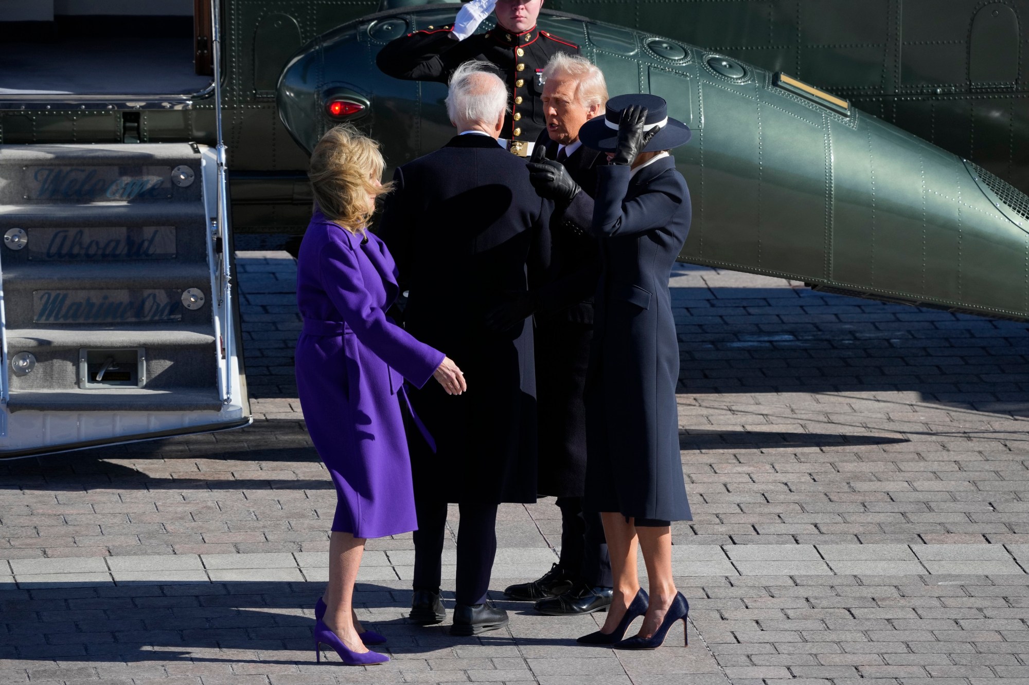 First lady Melania Trump, from right, and President Donald Trump send off former President Joe Biden and Jill Biden as the Bidens board a Marine helicopter en route to Joint Base Andrews after the 60th Presidential Inauguration, Monday, Jan. 20, 2025, at the U.S. Capitol in Washington. (Jack Gruber/Pool Photo via AP)