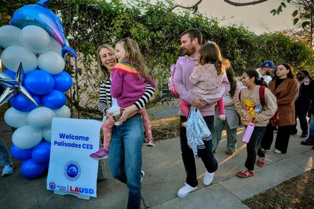 Palisades Charter Elementary School students and their parents arrive at their new school