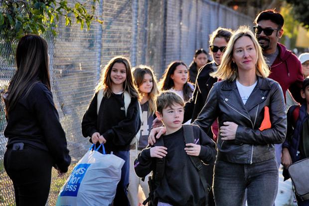 Palisades Charter Elementary School students and their parents arrive at their new school