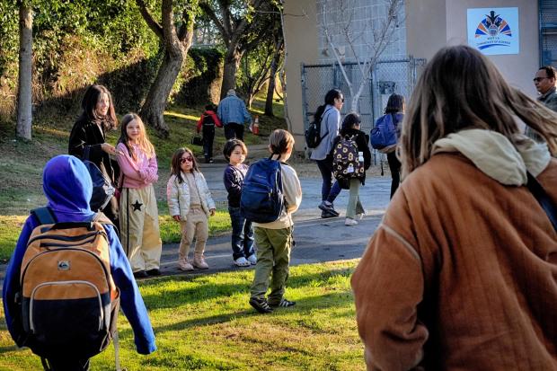 Palisades Charter Elementary School students and their parents arrive at their new school