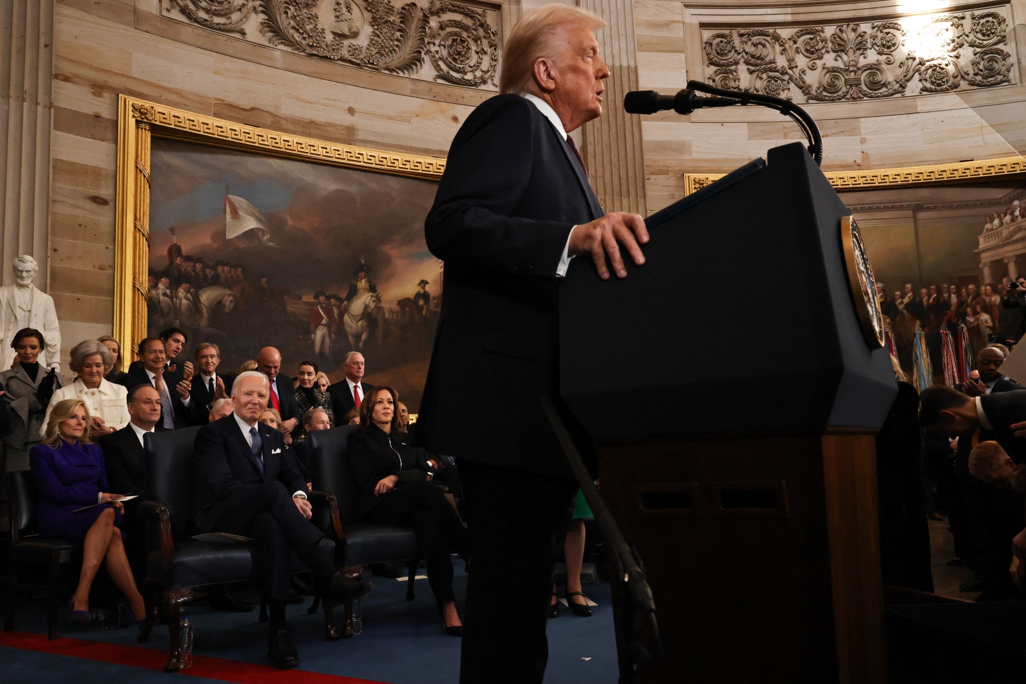 US President Donald Trump speaks as former US President Joe Biden and former US Vice President Kamala Harris look on during inauguration ceremonies in the Rotunda of the US Capitol on January 20, 2025 in Washington, DC. Donald Trump takes office for his second term as the 47th president of the United States. (Photo by Chip Somodevilla / POOL / AFP) (Photo by CHIP SOMODEVILLA/POOL/AFP via Getty Images)