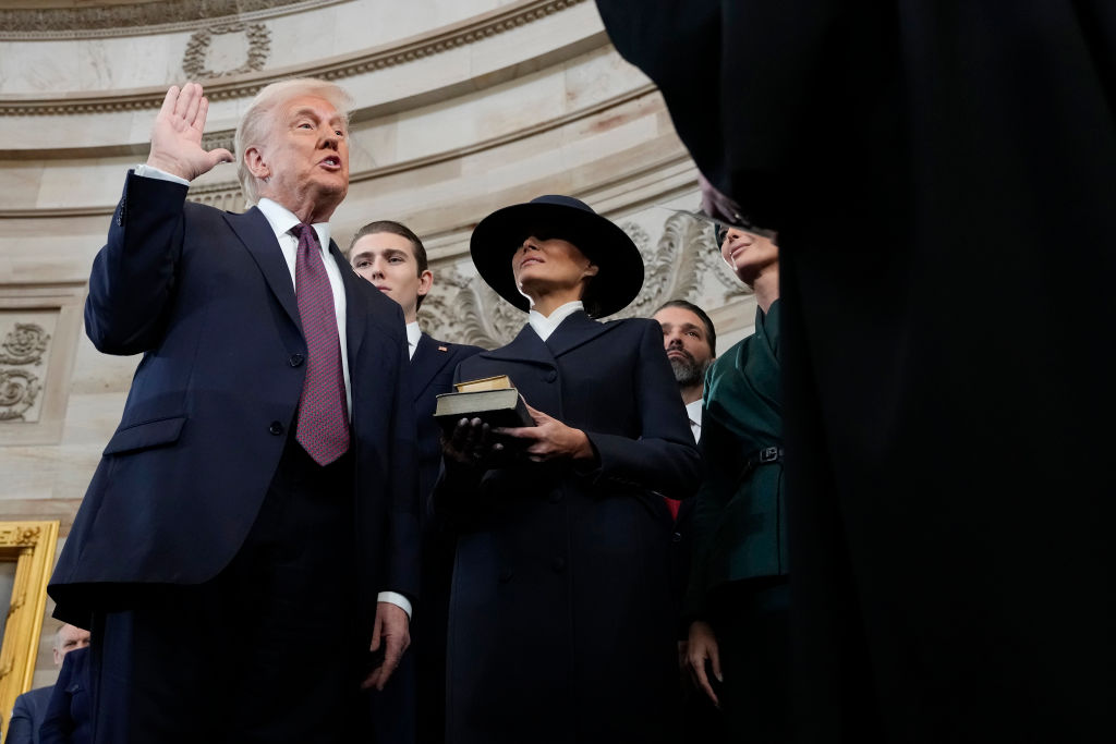 WASHINGTON, DC - JANUARY 20: U.S. President Donald Trump takes the oath of office from Chief Justice John Roberts as Barron Trump and Melania Trump look on during inauguration ceremonies in the Rotunda of the U.S. Capitol on January 20, 2025 in Washington, DC. Donald Trump takes office for his second term as the 47th President of the United States. (Photo by Morry Gash - Pool/Getty Images)