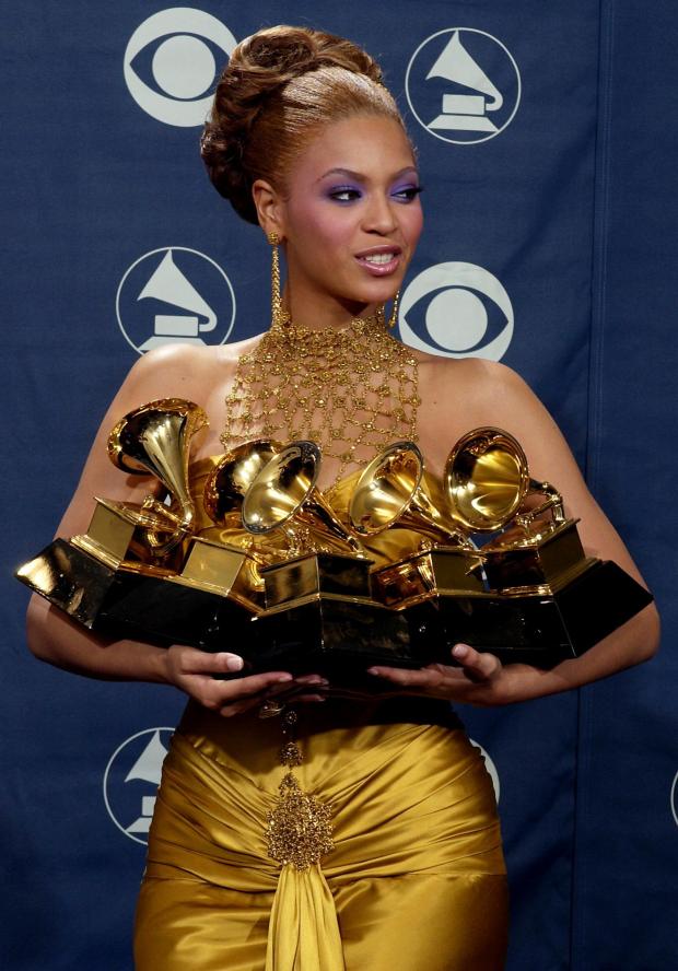 Beyonce Knowles holds the Grammy awards she won during the 46th Annual Grammy Awards