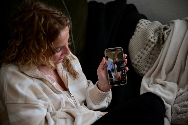 Lilly Downs, 20, shows one of her TikTok videos of her dancing with a sibling, at her apartment in Fort Collins, Colorado on Thursday, Oct. 17, 2024. (Photo by Hyoung Chang/The Denver Post)