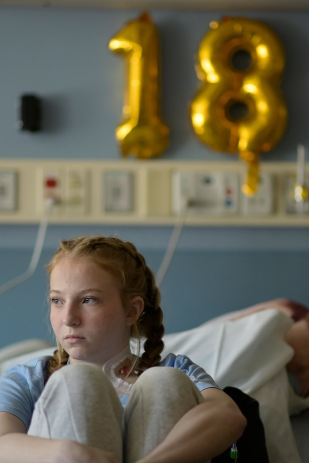 In this file photo from Aug. 30, 2022, Lilly Downs, then 18, sits in her bed at Denver's Rocky Mountain Hospital for Children. (Photo by Hyoung Chang/The Denver Post)