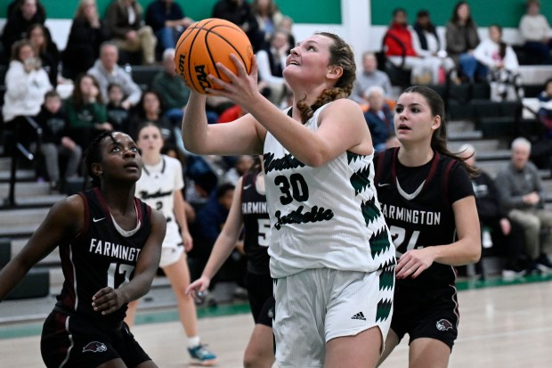 Northwest Catholic's Abby Casper (30) shoots against Farmington during a basketball game at Northwest Catholic High School Monday. Northwest Catholic won 54-45. (Jessica Hill/Special to the Courant)