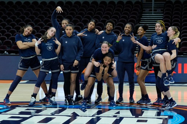 UConn players pose for photographs during a practice for an NCAA Women's Final Four semifinals basketball game Thursday, April 4, 2024, in Cleveland. (AP Photo/Carolyn Kaster)